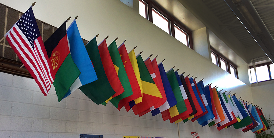 Photograph of the flags hanging in our main lobby. The American flag is on the far left. At least 41 nations are represented. 